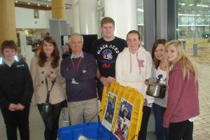 Students at South Cheshire College with President Jerry Park discussing Life Aid Boxes